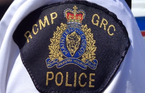 A black badge that reads RCMP, GRC, Police.