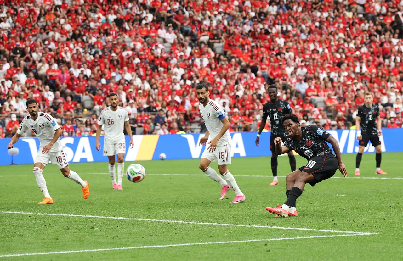 A soccer player shoots on net.