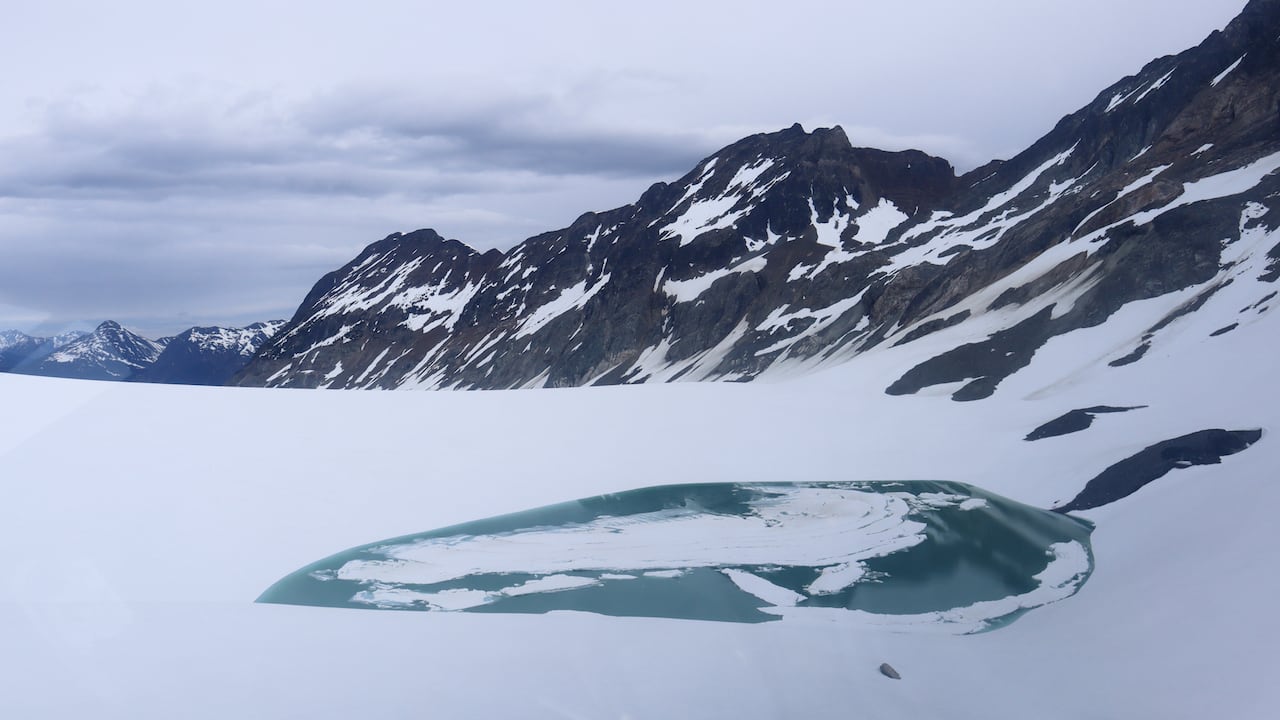 A lake beside a glacier.