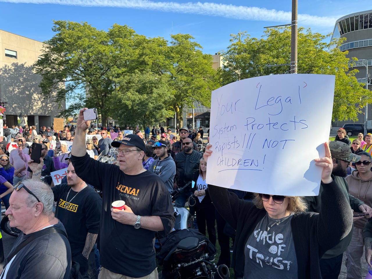 a group of people holds signs 