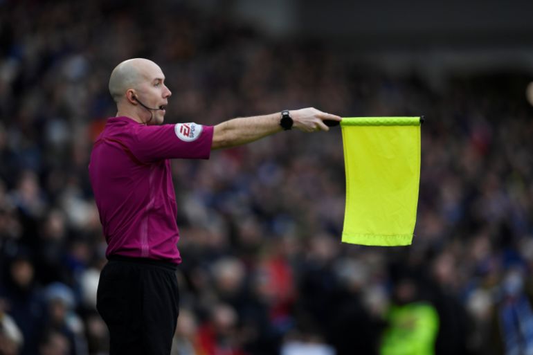Soccer Football - Premier League - Brighton & Hove Albion vs Arsenal - The American Express Community Stadium, Brighton, Britain - March 4, 2018 An assistant referee raises the flag for offside against Brighton Action Images via Reuters/Tony O'Brien EDITORIAL USE ONLY. No use with unauthorized audio, video, data, fixture lists, club/league logos or "live" services. Online in-match use limited to 75 images, no video emulation. No use in betting, games or single club/league/player publications. Please contact your account representative for further details.
