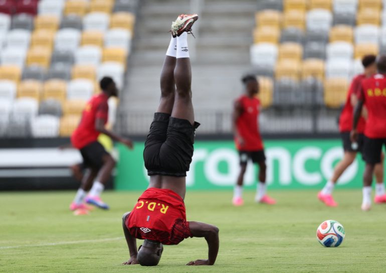 A DR Congo player stands on his head during training in Houston.