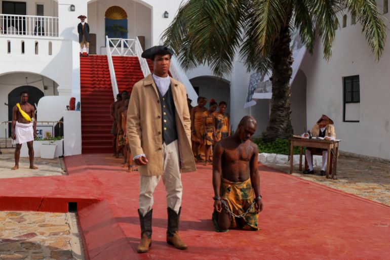 Performers re-enact the transatlantic slave trade at Christiansborg Castle, a former slave post, during a conference on follow-up to a UN resolution on trafficking of enslaved Africans, in Accra, Ghana [/Francis Kokoroko/Reuters]