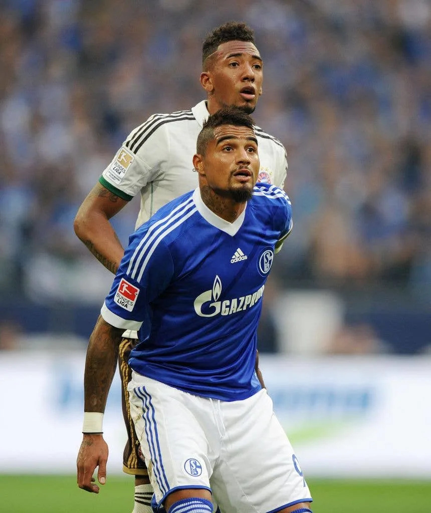 Jérôme and Kevin Prince Boateng compete for the ball in a 2013 football match.