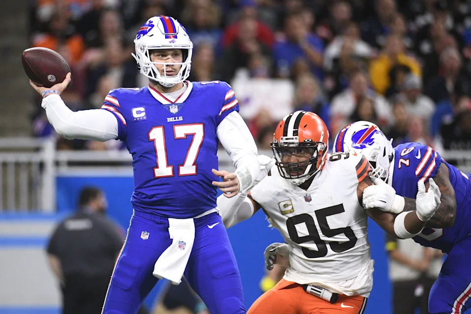 Nov 20, 2022; Detroit, Michigan, USA; Buffalo Bills quarterback Josh Allen (17) drops back to throw the ball as guard Rodger Saffold (76) blocks Cleveland Browns defensive end Myles Garrett (95) during the first half at Ford Field. Mandatory Credit: Tim Fuller-USA TODAY Sports