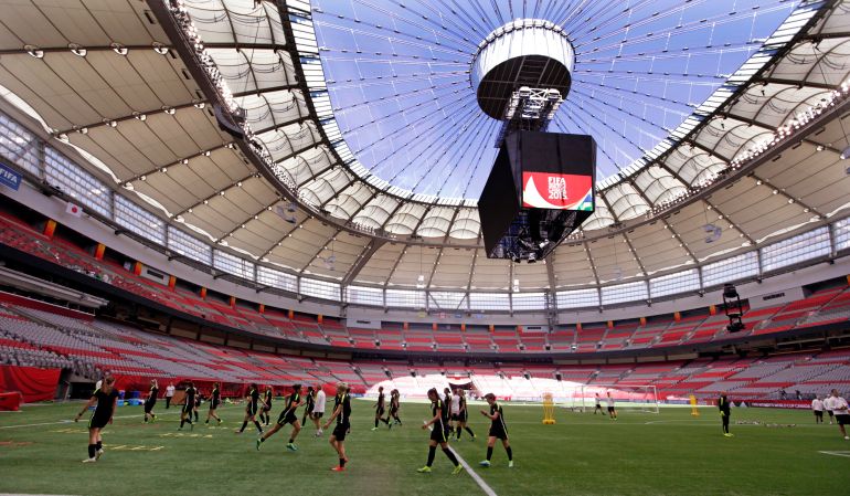 FILE - U.S. players run drills during a practice for the Women's World Cup soccer final under the open roof of BC Place in Vancouver, British Columbia, Canada, Saturday, July 4, 2015. There are 23 venues bidding to host soccer matches at the 2026 World Cup in the United States, Mexico and Canada.(AP Photo/Elaine Thompson)