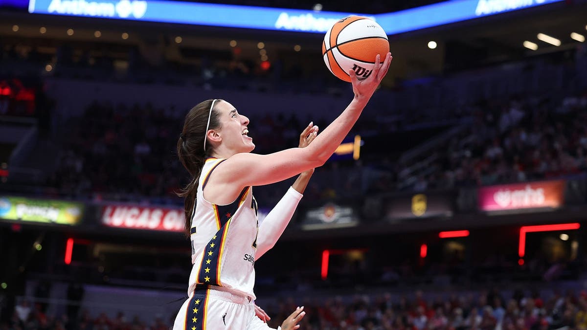 Caitlin Clark attemps a layup during a game