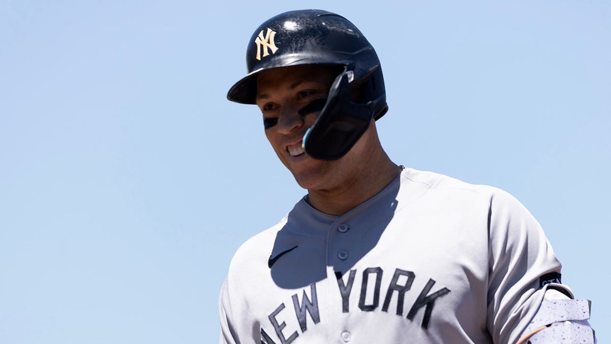 New York Yankees right fielder Aaron Judge smiling at teammates on field