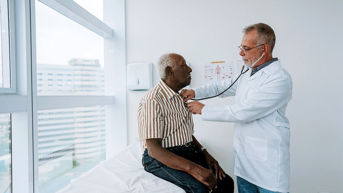 Doctor listening to a patient's heartbeat with a stethoscope.