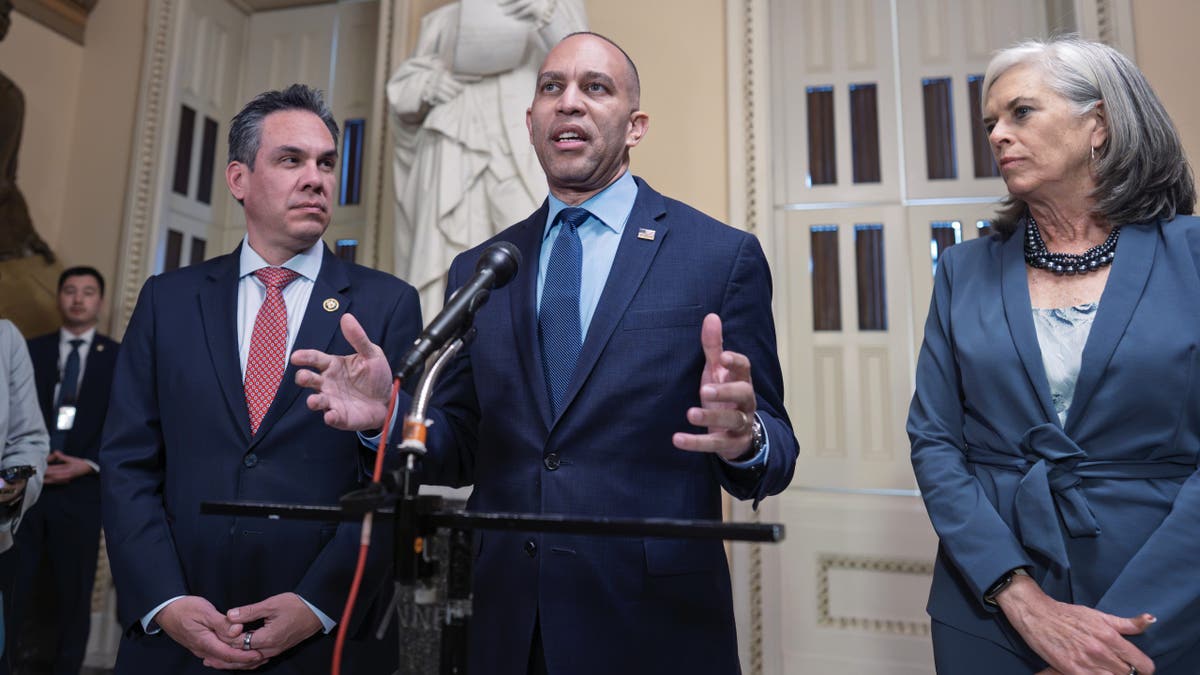 House Minority Leader Hakeem Jeffries speaking to reporters outside the House chamber flanked by Rep. Pete Aguilar and Rep. Katherine Clark