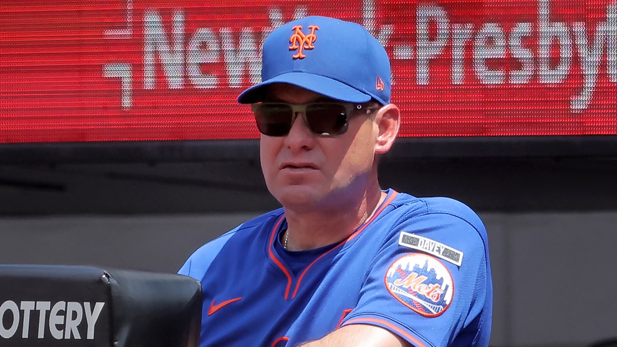 New York Mets manager Carlos Mendoza watching from the dugout at Citi Field.