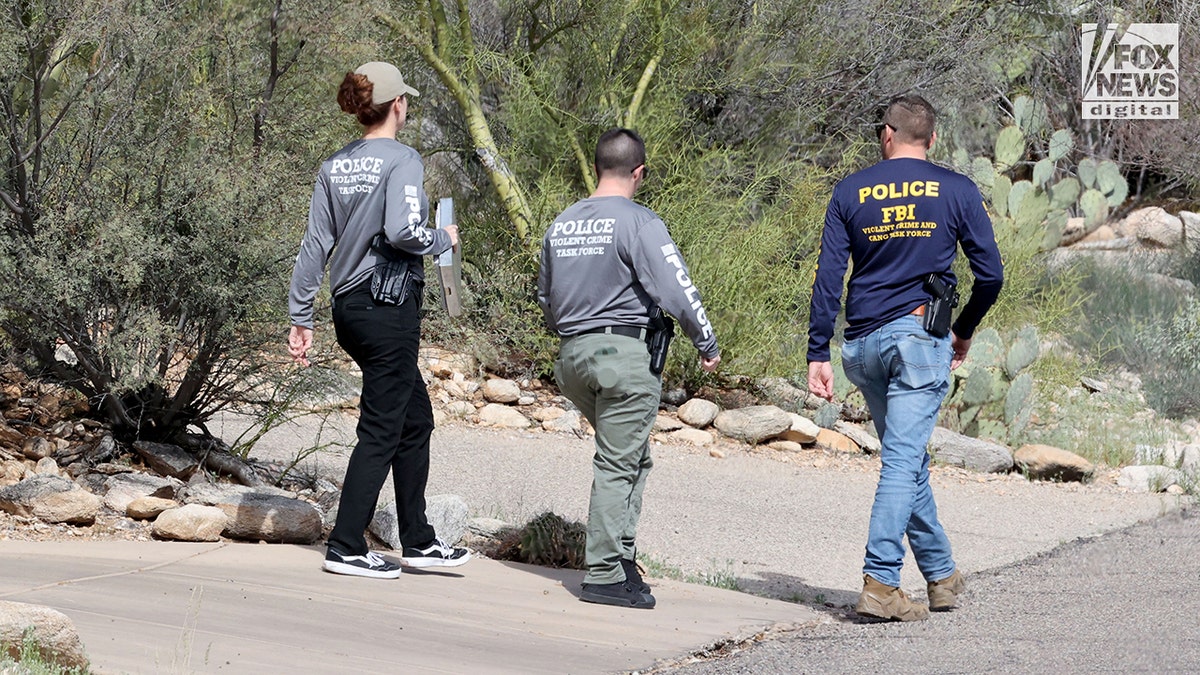 FBI agents and law enforcement officers walking door to door in Nancy Guthrie's neighborhood in Tucson, Arizona.