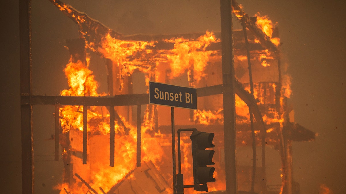 Flames burning a building on Sunset Boulevard during the Palisades Fire in Los Angeles