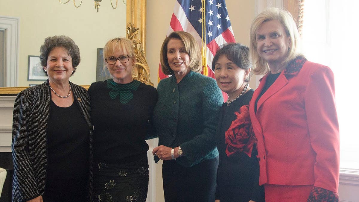 Actress Patricia Arquette standing with House Democratic Leader Nancy Pelosi and Representatives Carolyn Maloney, Doris Matsui, and Lois Frankel at the US Capitol