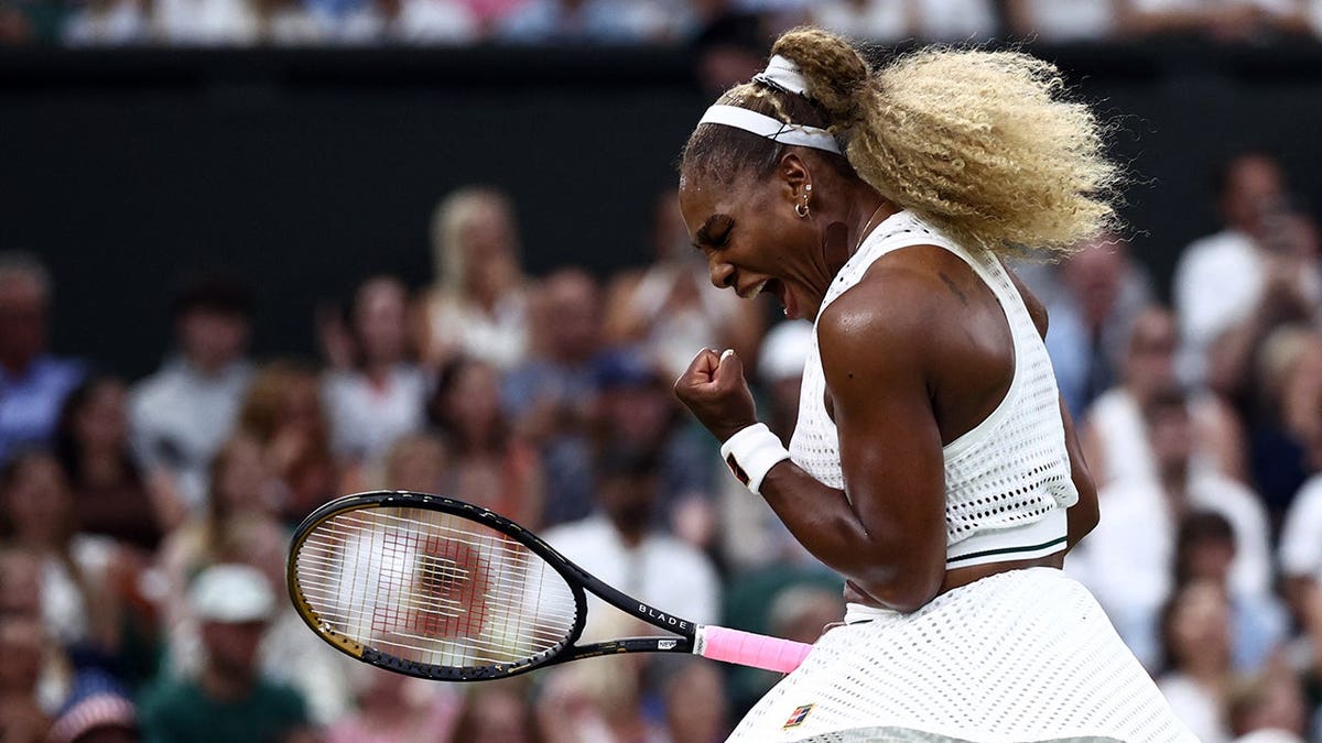 Serena Williams hitting a forehand during a tennis match at Wimbledon.