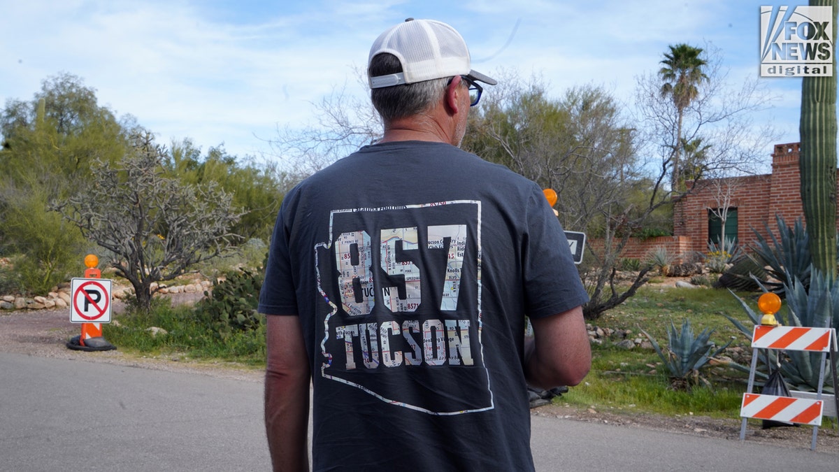 A man wearing a hat and shirt with 857 Tucson on it