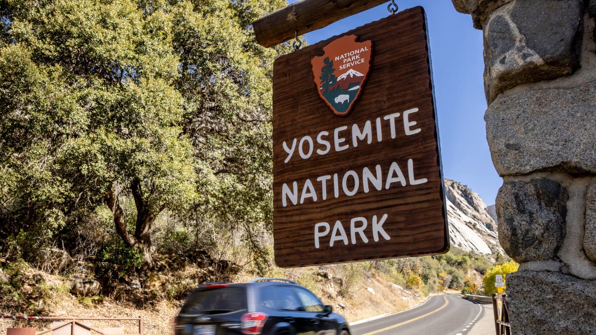 A Yosemite National Park sign standing outdoors in El Portal, California.