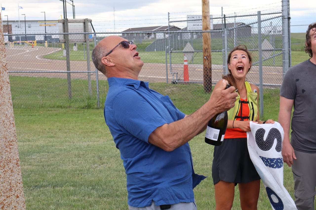 Man in blue shirt holds champagne