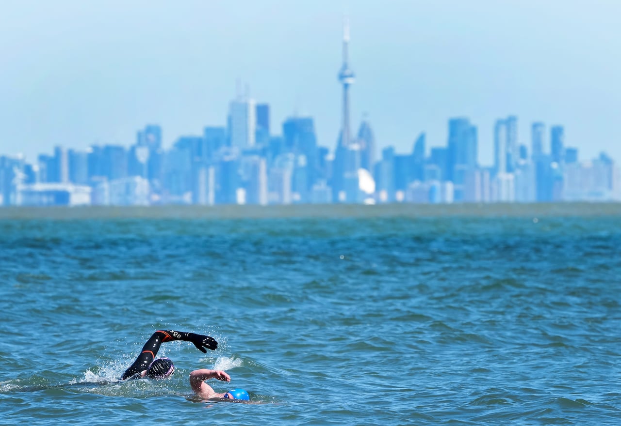 Two people swim in a lake