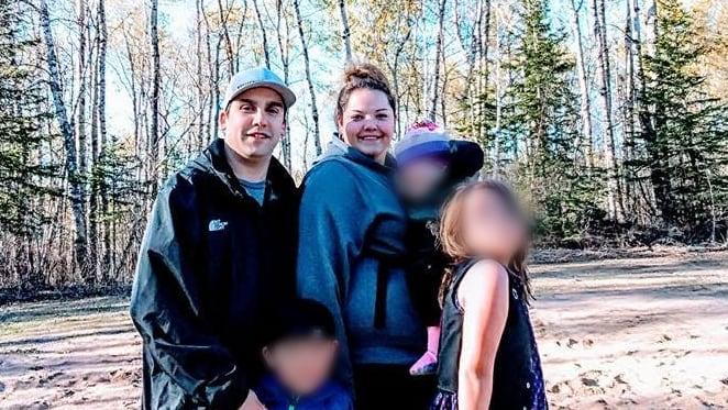 A family photo of a man and a woman with three children. The children's faces are blurred out.