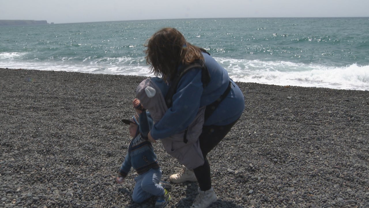 Roshell Rausch pulls her son back, after he ran toward the ocean at St. Vincent's beach.