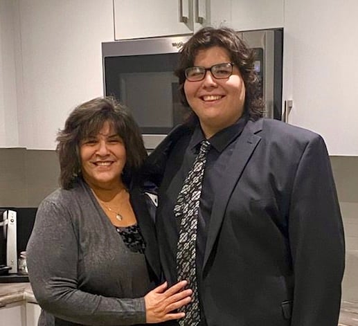 Janet Evans and Tyler Evans-Knott pose together for a photo.