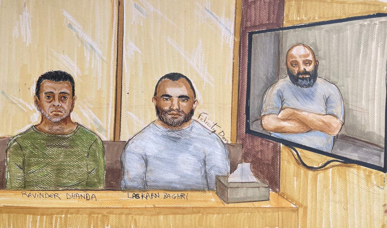 A court sketch of three men in a room, two sitting in person and one on a TV screen.