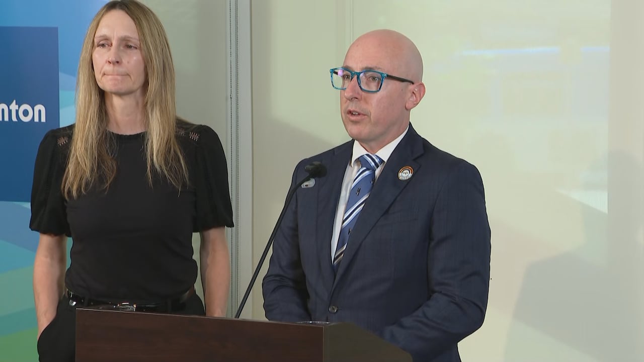 man and woman standing at podium with mic
