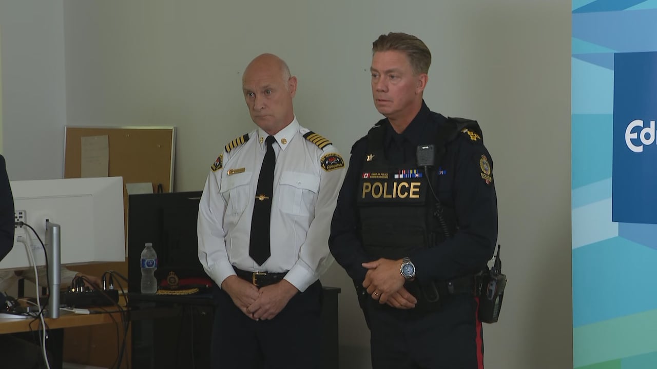 two men, one a police, and the other a fire guy