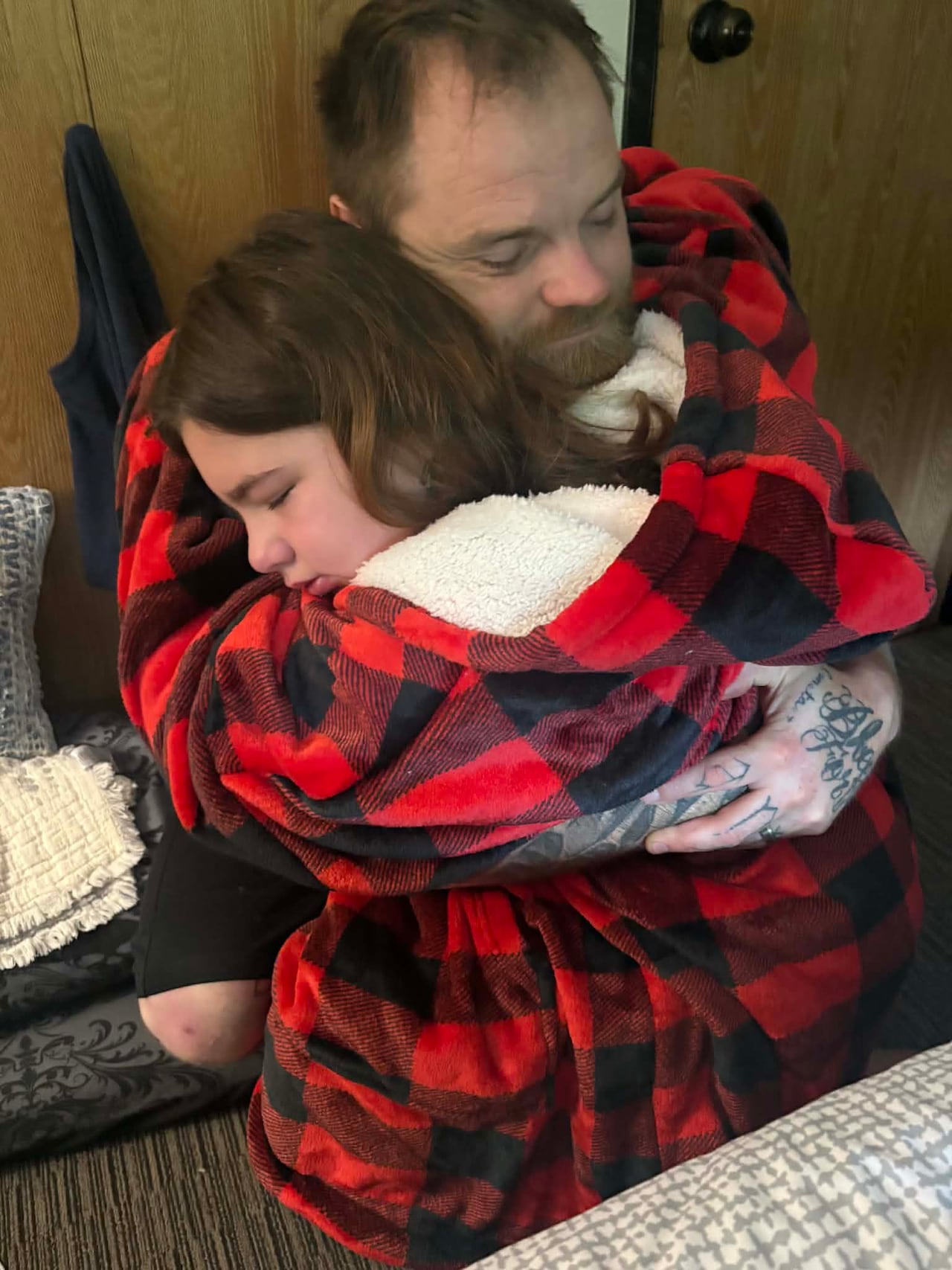 A father hugs his daughter.
