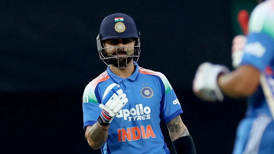 India's Virat Kohli celebrates his first run against Australia in Sydney