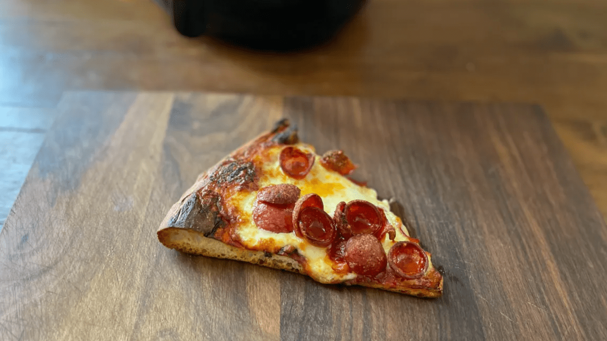 slice of pizza on a cutting board