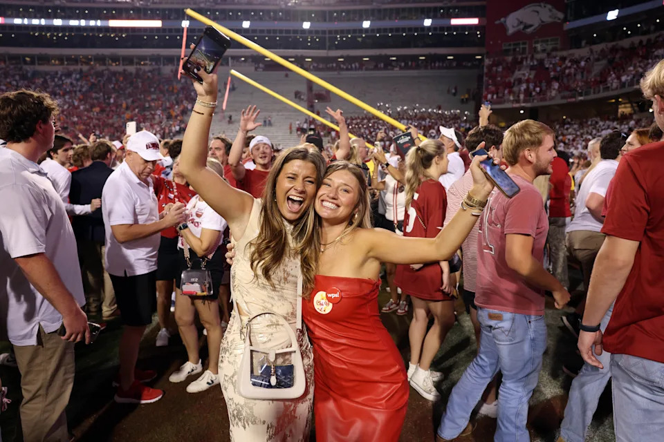 Oct 5, 2024; Fayetteville, Arkansas, USA; Arkansas Razorbacks fans celebrate in front of the downed goal posts after the game against the Tennessee Volunteers at Donald W. Reynolds Razorback Stadium. Arkansas won 19-14. Mandatory Credit: Nelson Chenault-Imagn Images