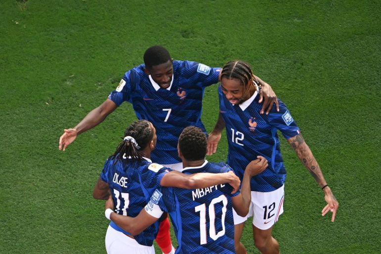 France's forward #10 Kylian Mbappe celebrates scoring his team's third goal with forward #07 Ousmane Dembele and forward #12 Bradley Barcola during the 2026 World Cup round of 32 football match between France and Sweden at the New York/New Jersey Stadium in East Rutherford on June 30, 2026. (Photo by MAURO PIMENTEL / AFP)