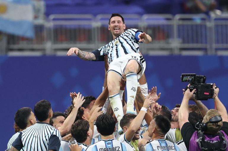 Argentina’s forward #10 Lionel Messi is lifted by teammates as they celebrate a come-from-behind victory against Egypt in the round of 16
