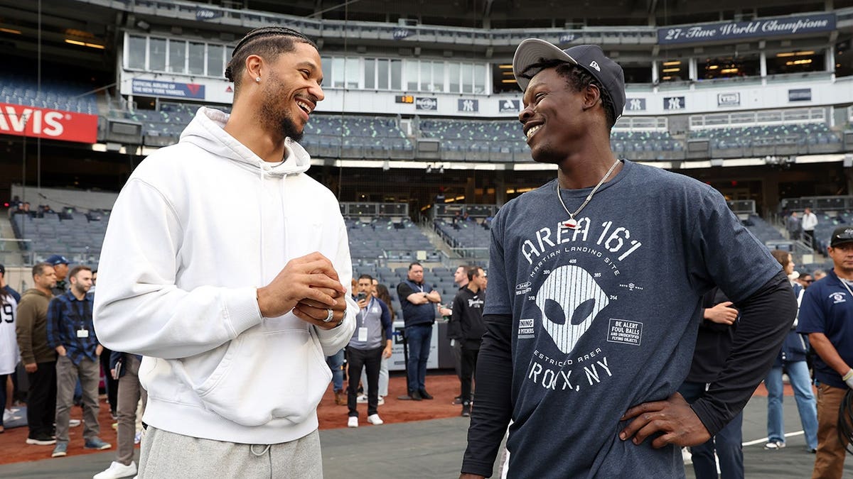 Josh Hart and Jazz Chisholm Jr. talk before a game at Yankee Stadium.
