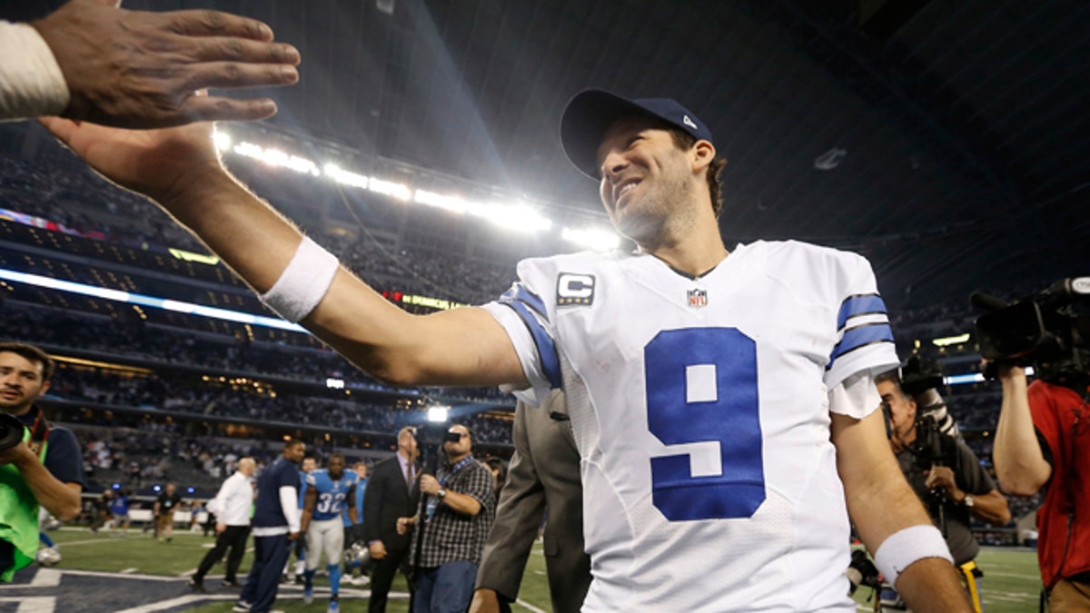 Dallas Cowboys quarterback Tony Romo (9) celebrates after an NFL wildcard playoff football game against the Detroit Lions, Sunday, Jan. 4, 2015, in Arlington, Texas. The Cowboys won 24-20. (AP Photo/Brandon Wade)