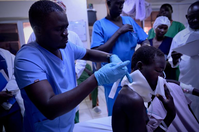 A nurse attending to a gunshot wound victim at Juba Military Hospital. The patient was evacuated from Ganyiel Primary Health Center to Juba by ICRC. [Handout/ICRC]