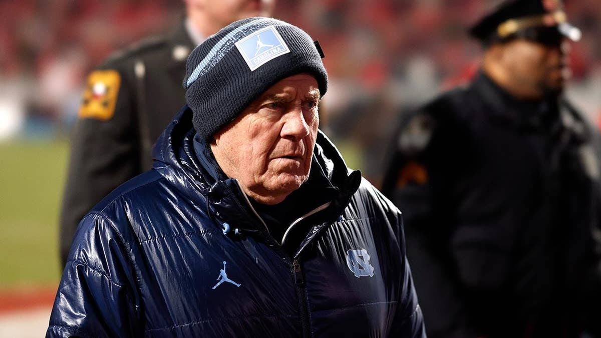 Bill Belichick walks off the field at Carter-Finley Stadium.