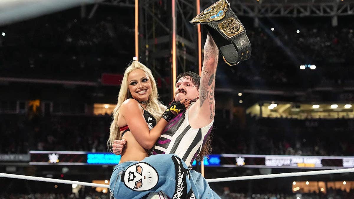 Liv Morgan and Dominik Mysterio celebrate at Petco Park.