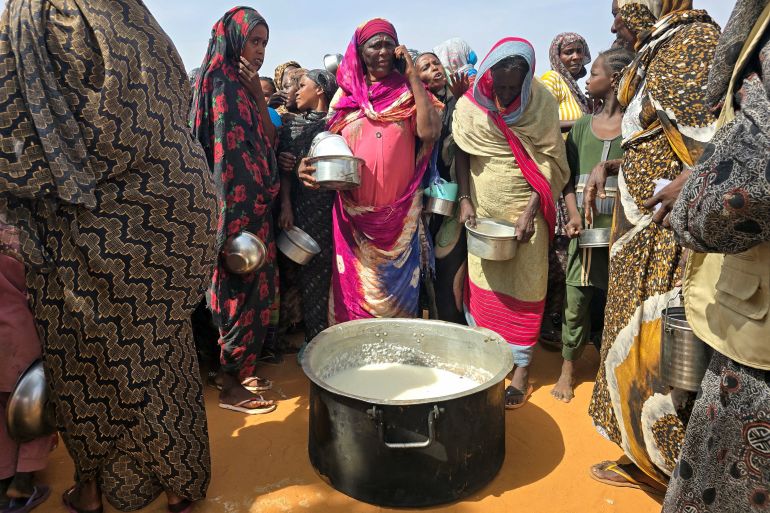 Sudanese women gather for a hot meal at al-Rahmaniyah camp for displaced people, near the city of el-Obeid in the southern Kordofan region, on July 7, 2026 [AFP]
