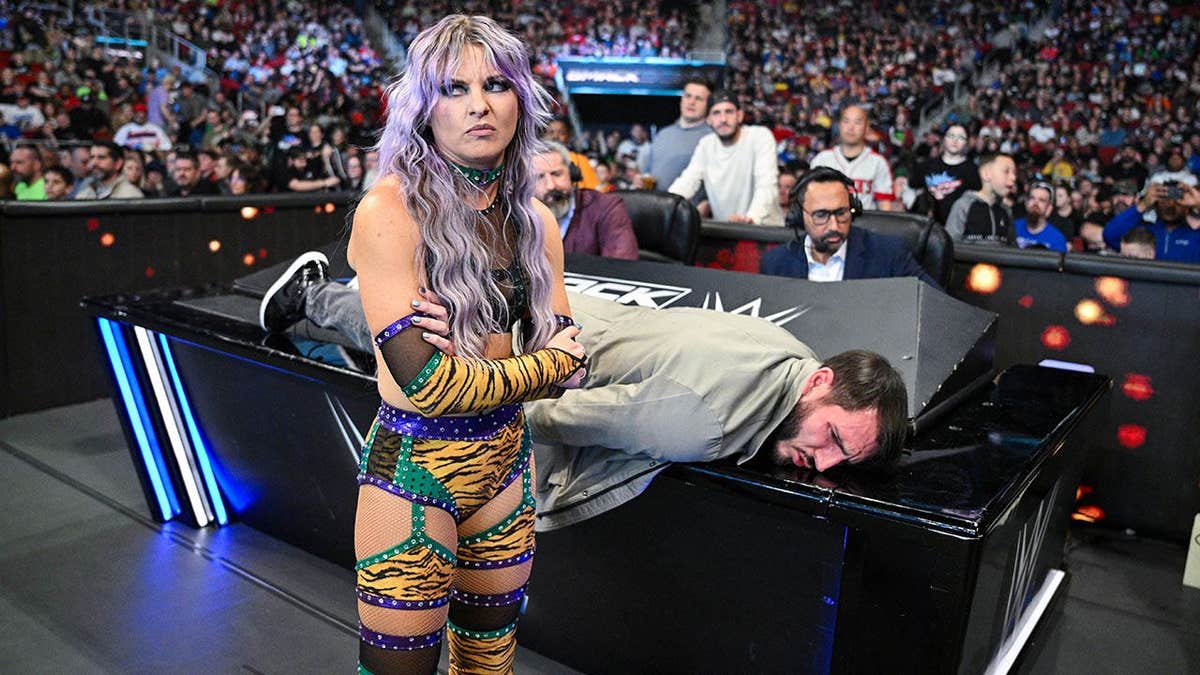 Candice LeRae and Johnny Gargano looking on during SmackDown at KFC YUM! Center in Louisville, Kentucky.