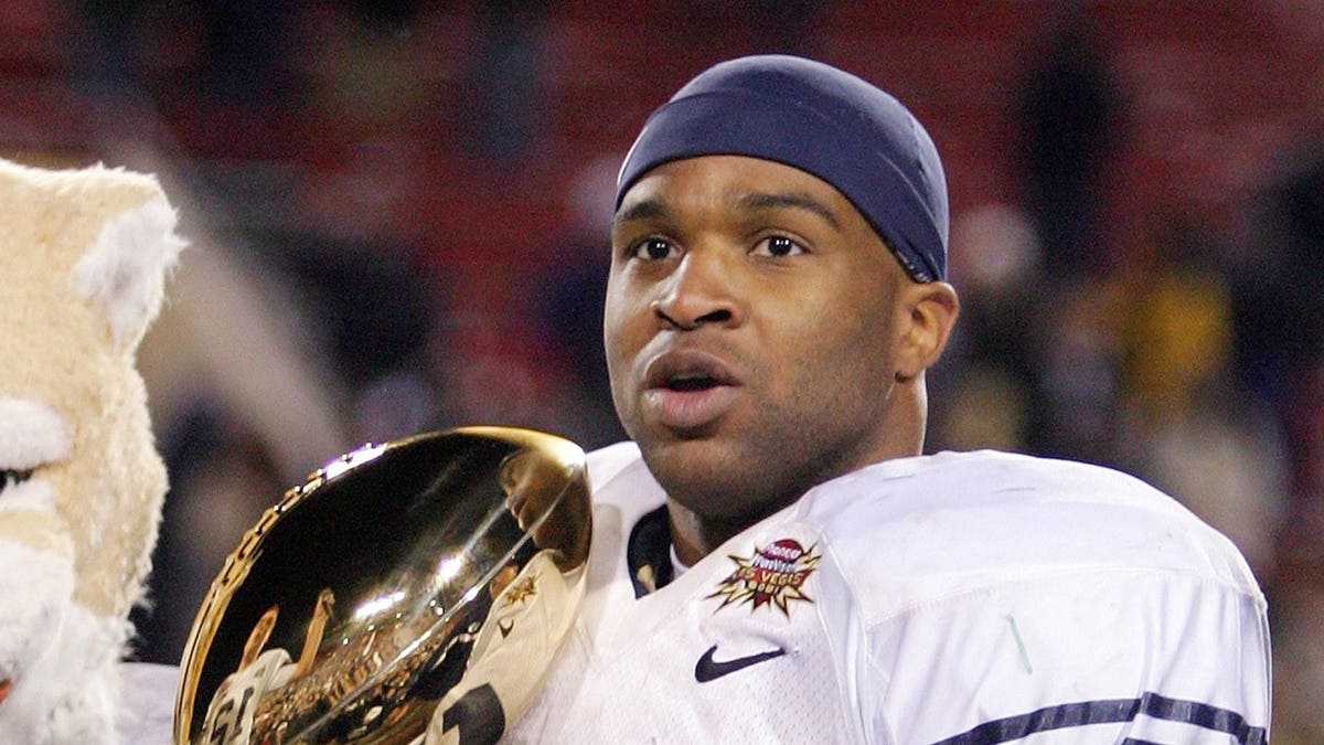 Curtis Brown holds the game trophy after BYU defeated Oregon in the Las Vegas Bowl.