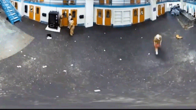 Inmate throwing basketball at security camera.