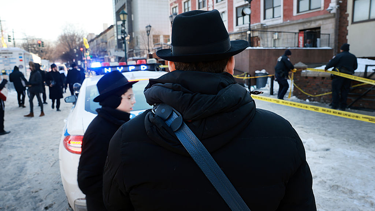 Hasidic Jewish community gather outside of the Chabad Lubavitch HQ