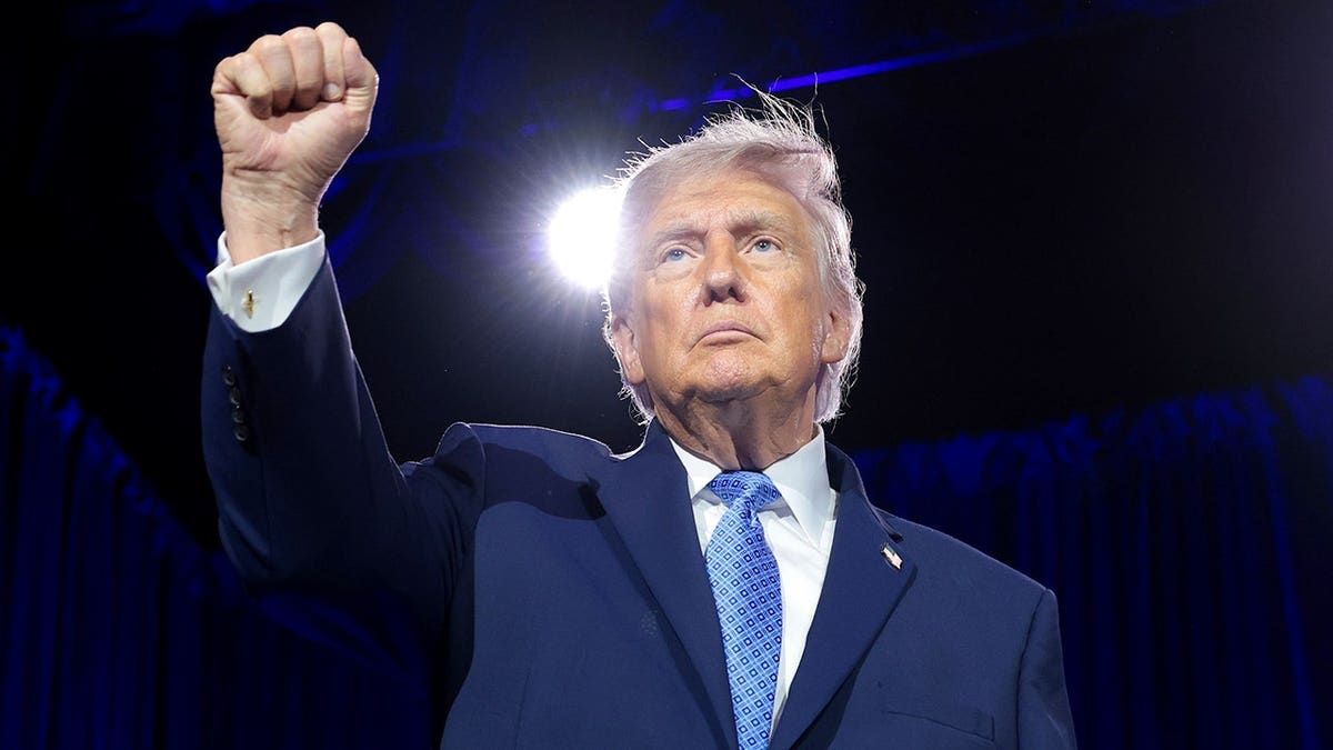 President Donald Trump holds up a fist