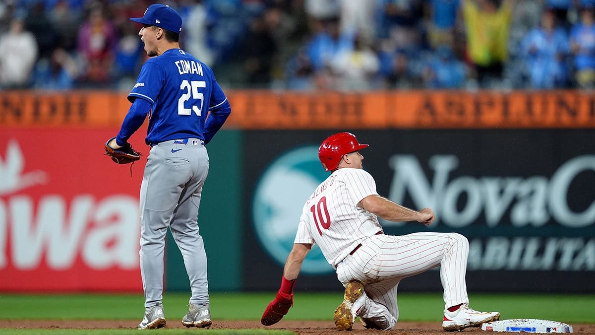 Tommy Edman reacts after tagging out JT Realmuto during a baseball game.