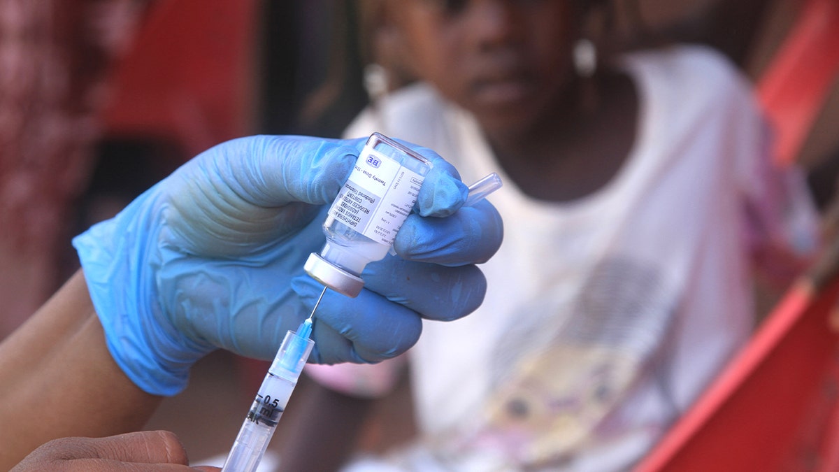 A Sudanese child looks on as a vaccination is prepared during a drive against diphtheria at the Al-Afad camp for displaced people in the town of Al-Dabba, northern Sudan, Nov. 22, 2025.