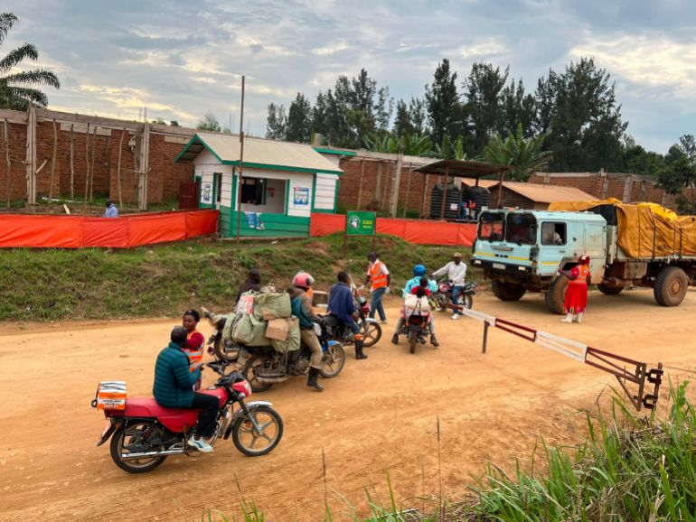 Motorbike riders have their temperatures checked by a Virunga National Park health agent at an Ebola screening checkpoint in northern Bunia, Democratic Republic of the Congo. [Prosper Heri Ngorora/Al Jazeera]