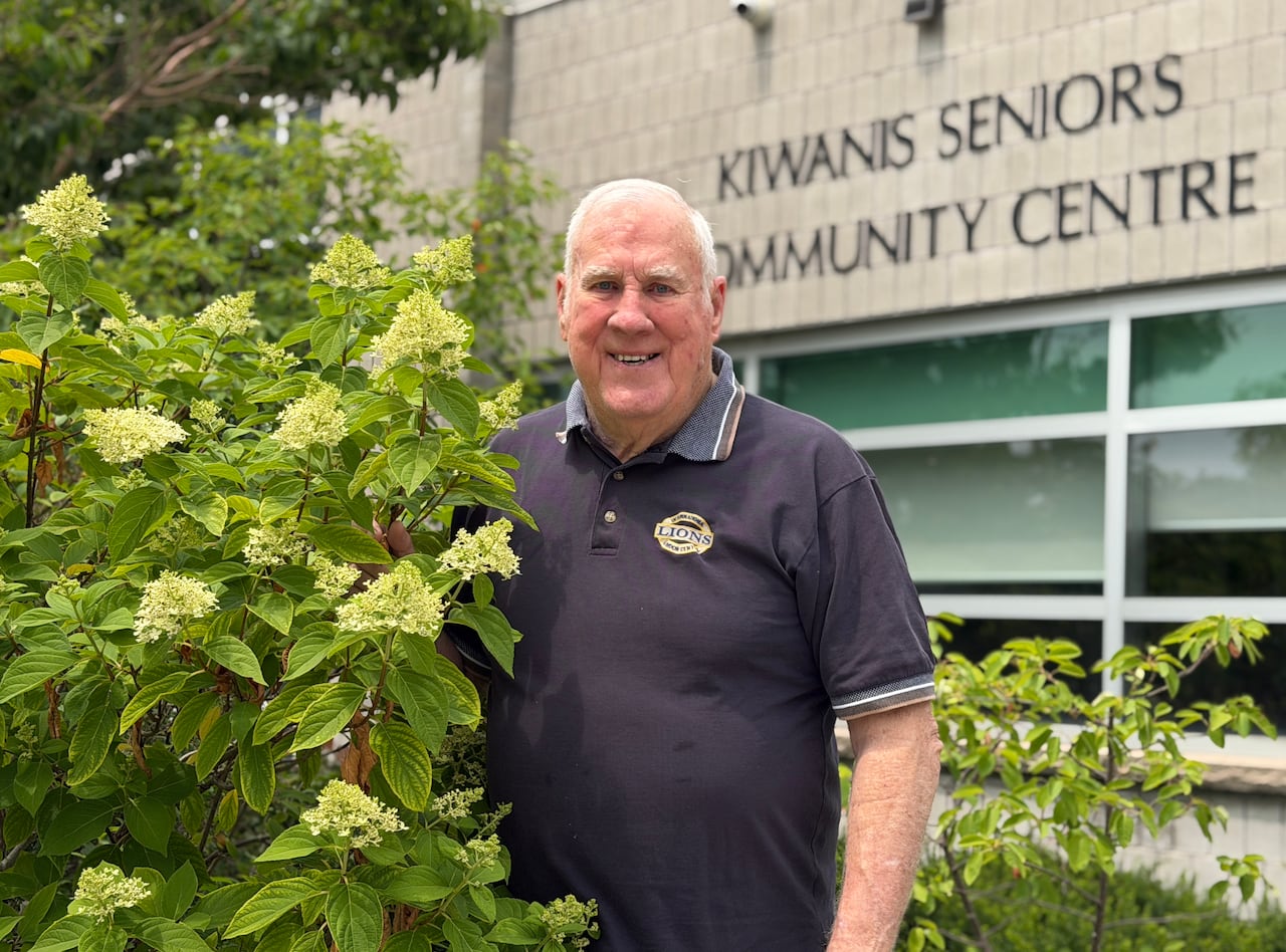 A man stands in front of the Kiwanis Seniors Community Centre